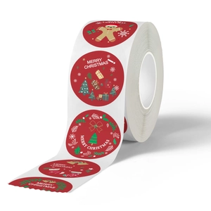 Roll of festive Merry Christmas round seal stickers with gingerbread man and tree designs