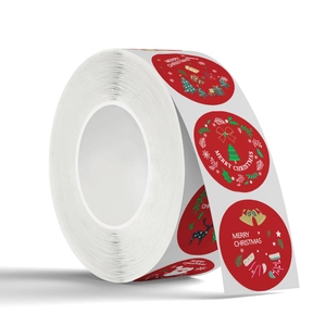 Roll of round red Christmas stickers with festive patterns and Merry Christmas text