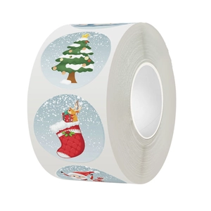 Close-up of circular Christmas gift labels roll with Santa and reindeer motifs