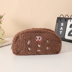 Detailed view of dark brown teddy plush pouch with cartoon embroidery and zipper closure
