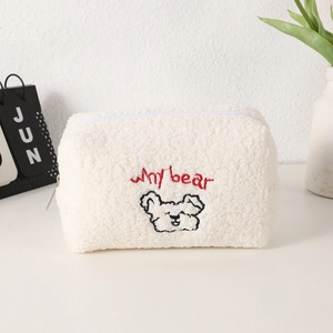 Detail of white fluffy bear pencil case featuring Why bear embroidery and soft texture