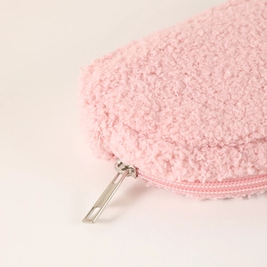 Detail of pink plush pencil case featuring a durable metal zipper and soft faux fur texture