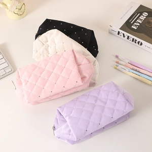 Quilted cosmetic bags in black, cream, pink, and purple with small rhinestone accents