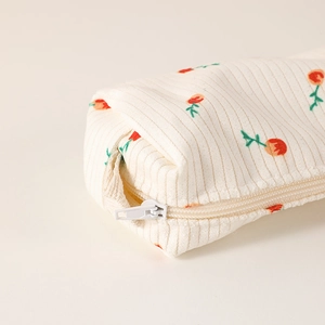 Detailed close-up of corduroy texture and floral tulip pattern on this aesthetic pencil case