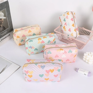 Quilted heart pencil case set in cream and pastel colors with gold zipper closure