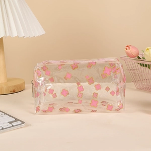 Detail of pink clover pattern on transparent PVC pencil case with a smooth zipper