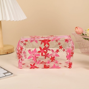 Macro detail of waterproof transparent PVC pencil case with cute pink floral prints