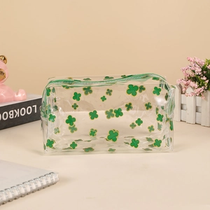 Macro shot of waterproof PVC pouch featuring green clover prints and a secure zipper top