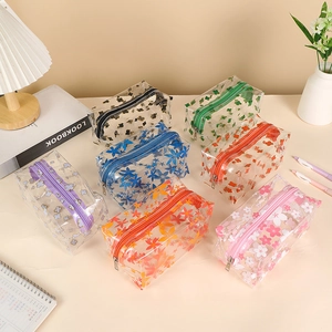 Floral transparent PVC pencil case set in seven colors displayed on a cozy desk setup