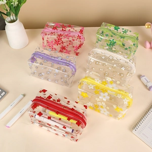 Clear floral PVC pencil cases with zippers organized on a desk for stationery storage