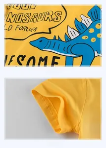 Detailed view of dinosaur print and double-needle stitching on a yellow cotton kids t-shirt