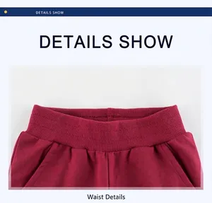 Close-up of red kids sports pants featuring elastic waistband and side pockets