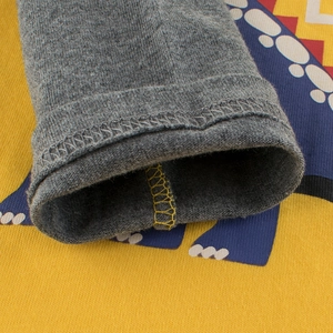 Close-up of grey cotton knit sleeves with colorful geometric prints for boys' tops