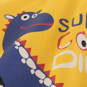 Close-up of yellow cotton long sleeve T-shirt for boys with blue dinosaur print
