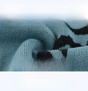 Detailed macro view of soft, breathable blue and black leopard knit fabric for kids' sweaters