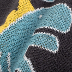 Kids knitted sweater featuring vibrant yellow blue and black geometric pattern design