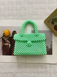Chic mint green hand-woven beaded handbag with top handle and elegant flip cover