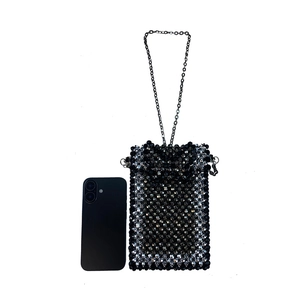 Detail of handmade beaded phone bag with metal chain next to a smartphone for size