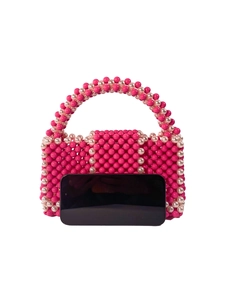 Handmade beaded handbag in rose pink and cream white with curved handle on white background