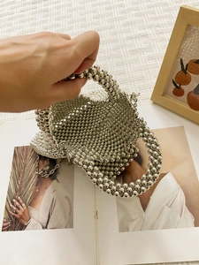 Silver metallic beaded handbag with chain strap and spacious interior for women