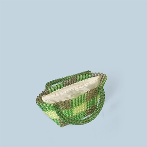 Detail of beaded woven handbag showing green striped pattern, satin lining and zipper