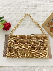 Detail of hand-woven gold metal sequins and beadwork on a vintage style tote bag