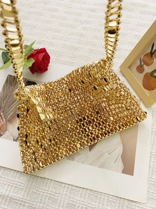 Detail of hand-woven gold metal bead chain bag with vintage shimmering sequin texture