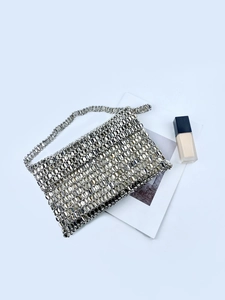 Detailed close-up of handmade silver metallic sequin tote with fine chain strap