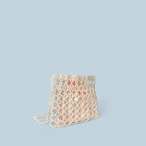 Detail of beaded pearl bag with pink satin drawstring lining and openwork weave texture