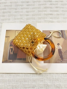 Handmade amber beaded bucket bag with tortoiseshell ring handle and satin drawstring lining