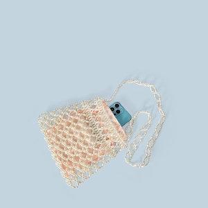 Detailed view of handmade beaded bag with ivory pearls and pink satin drawstring liner