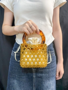 Detail of amber acrylic beads and satin drawstring lining on handmade bucket bag