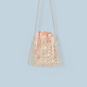 Detail of beaded crossbody bag with creamy faux pearls and a pink satin drawstring lining