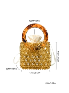 Detail view of handmade amber beaded bucket bag with tortoiseshell handle and drawstring liner