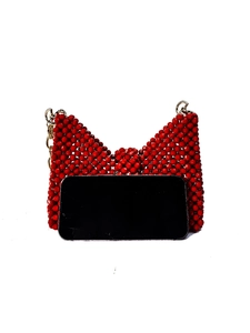 Handmade red beaded bow bag with gold chain strap, showing size with a smartphone