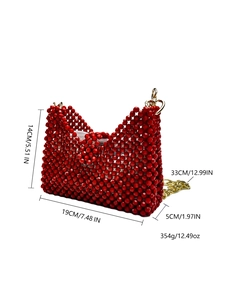 Detail view of red beaded handbag showing dimensions 19x14x5cm with gold heart clasp