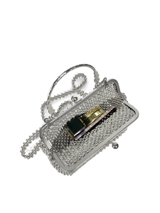 Silver beaded evening bag interior view showing lipstick and makeup storage space