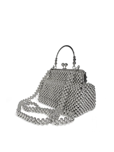 Close-up of silver beaded handbag featuring vintage engraved handle and bead-clasp closure