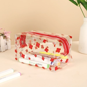 Macro shot of large capacity transparent PVC pencil case with red clover pattern and zipper
