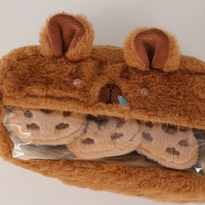 Close-up of brown plush capybara pencil case with soft faux fur and clear PVC window