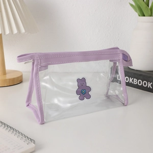 Macro detail of purple cartoon bear pencil case with transparent PVC and zipper closure