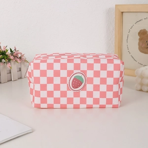 Close-up of pink checkered canvas makeup bag with strawberry patch and metal zipper detail