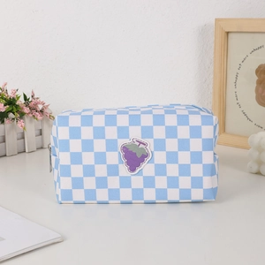 Detailed shot of blue checkered canvas bag with purple grape embroidery and silver zipper