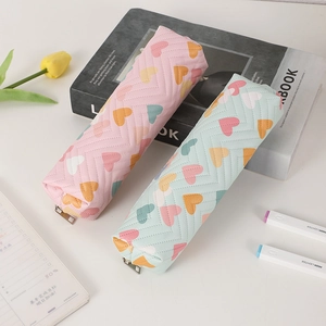 Close-up of PU leather pencil case featuring heart prints and V-shaped quilting detail