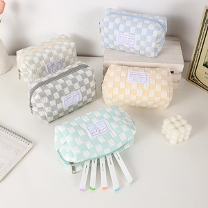 Close-up of checkered woven pencil cases in pastel colors with sweet girl labels