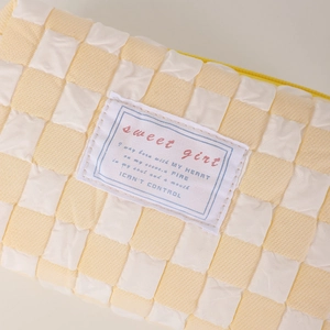 Detail shot of 3D bubble textured checkerboard pencil case with smooth yellow zipper closure