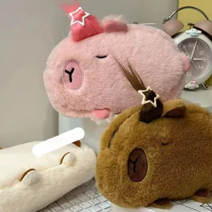 Close-up of cute plush capybara pencil cases in pink, brown, and off-white colors