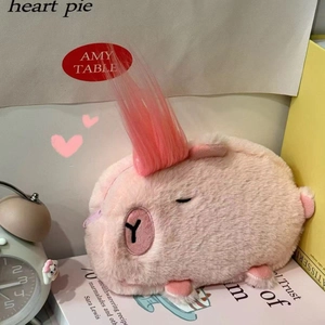 Detailed close-up of a pink plush capybara pencil case with soft faux fur and embroidery
