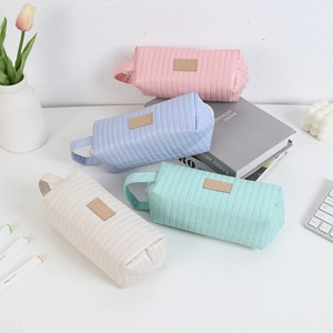 Close-up of quilted PU leather pencil cases in pastel pink, purple, white and green