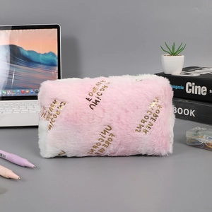 Close-up of pink plush stationery bag with gold Forever Unicorns embroidery text